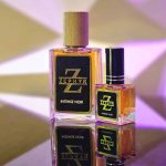 Zephyr Intense Noir Eau De Parfum premium transparent glass bottles in 30ml with wooden cap and 10ml with black cap on a reflective surface.